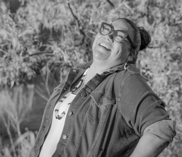 black and white image of Marisa Page laughing with joy